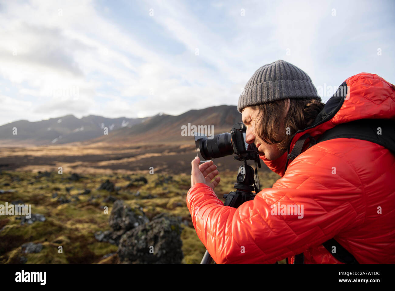 A photographer taking photos at sunset in Iceland. Stock Photo