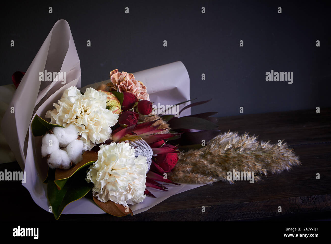 Close-up bouquet decorated in vintage style on a dark background, selective focus Stock Photo