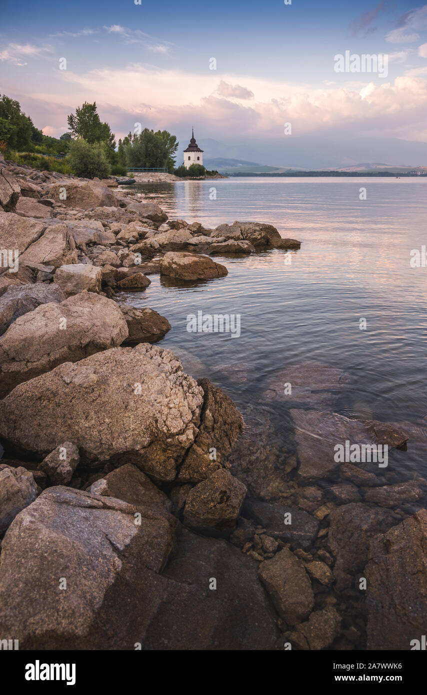 Church on Rocky Beach of Liptovska Mara Lake in Slovakia Stock Photo