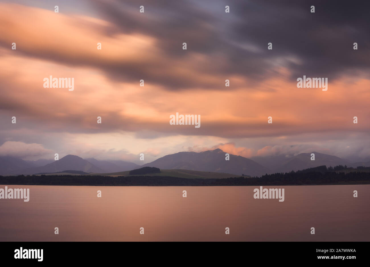 Long Exposure Shot of Liptovska Mara Lake, Low Tatras Mountains and Cloudy Sky at Sunset. Stock Photo