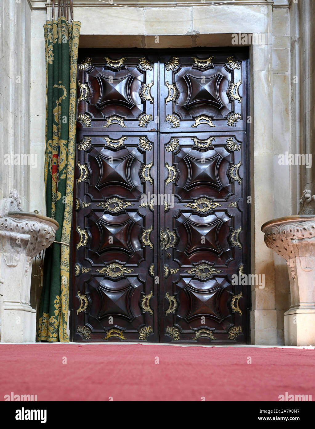 Interior view of the magnificent blackwood entry door with gilded bronze application of the Church of the Monastery of Saint Mary of Lorvao, Coimbra, Stock Photo