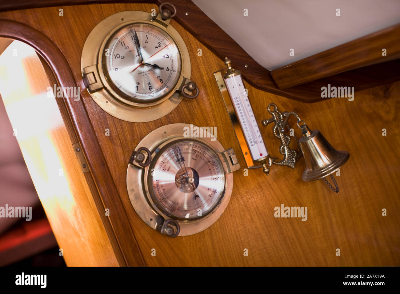 Barometer with a bell and a clock and temperature gauge on a boat Stock Photo Alamy