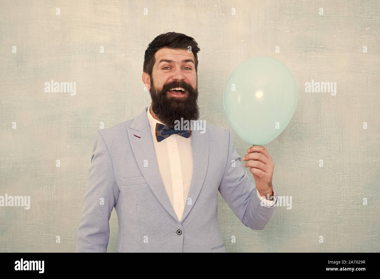 Lets have fun. Man groom blue tuxedo bow tie hold air balloon. Wedding ...