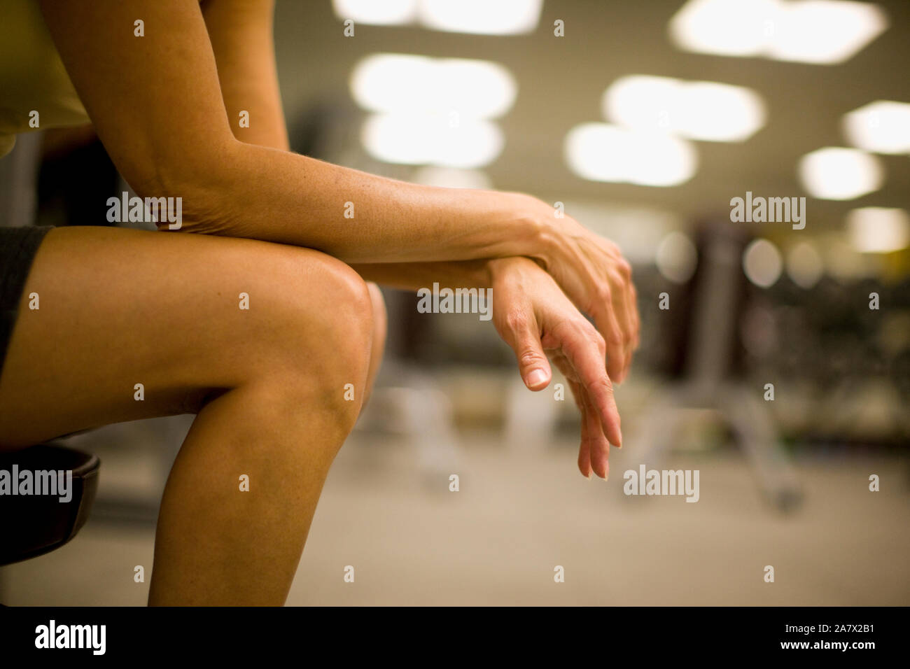 Women's hands and legs resting in a gym Stock Photo - Alamy