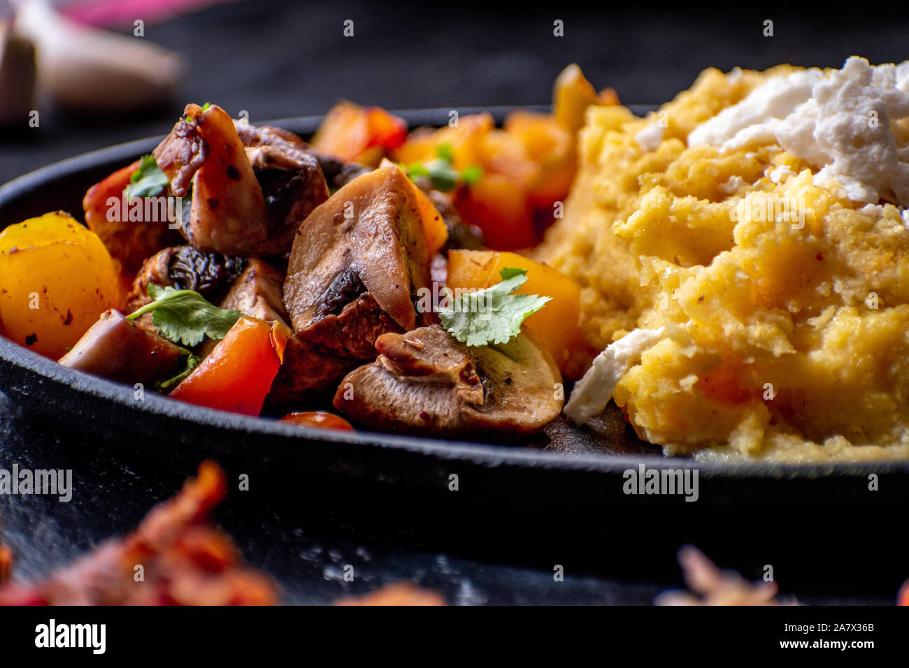 Traditional mamaliga, corn mush, along with vegan meat, sauerktaut, mixed vegetables Stock Photo
