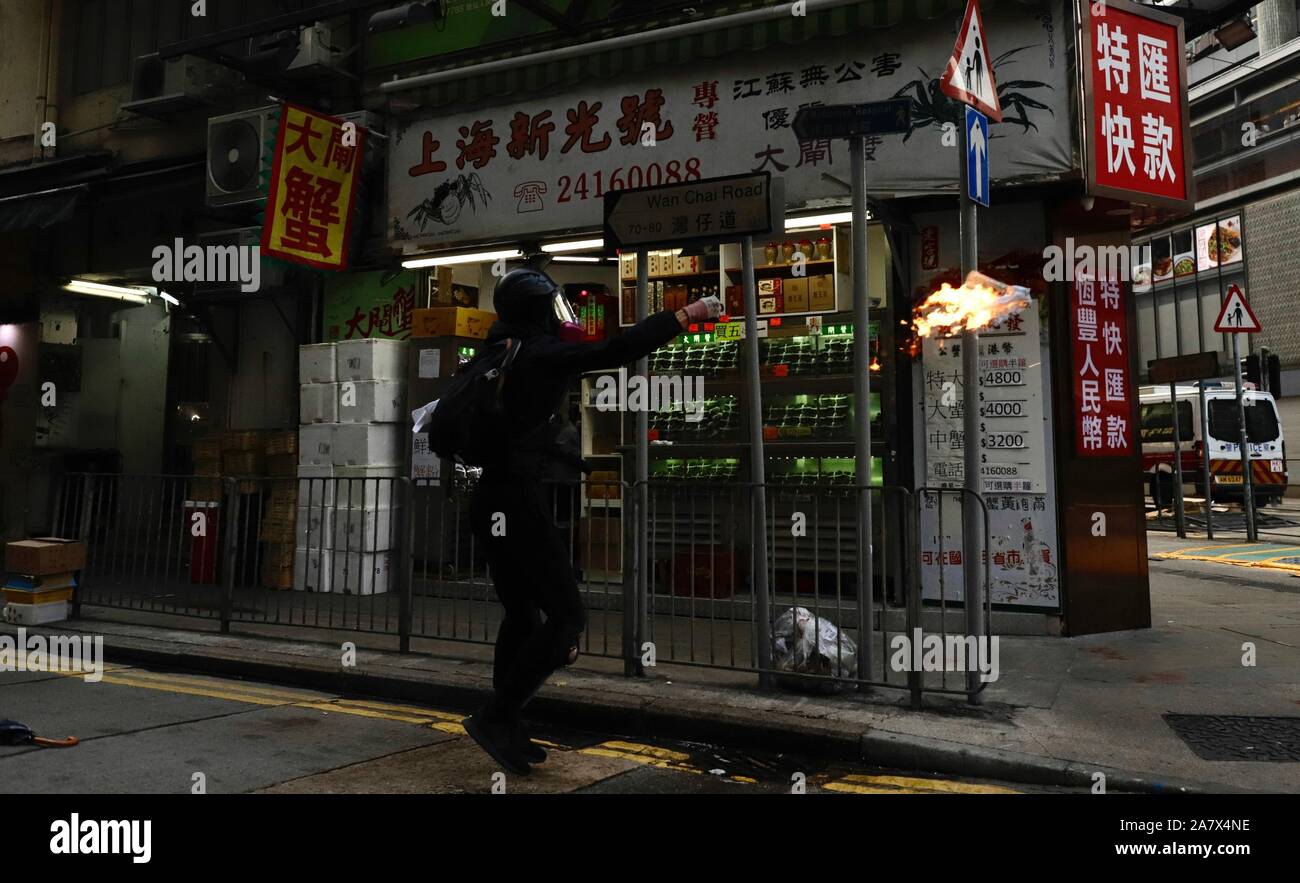 Hong Kong, CHINA. 2nd Nov, 2019. Protester throw petrol bomb ( Molotov Cocktail ) at the riot police from the alley. Hong Kong protest and civil unrest continue into fifth months showing no sign of dissipation. Credit: Liau Chung-ren/ZUMA Wire/Alamy Live News Stock Photo