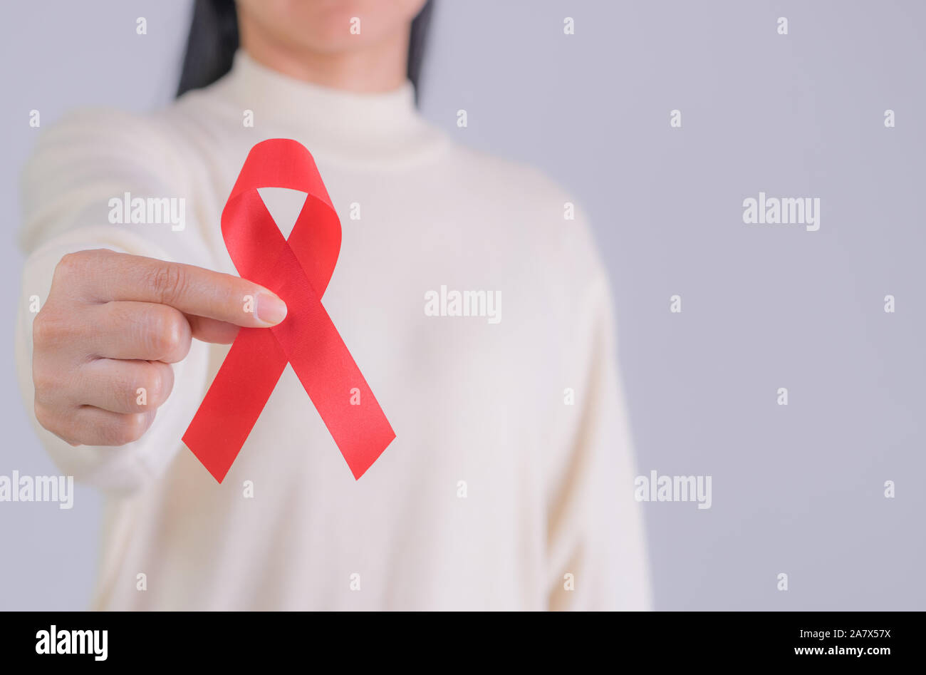 Aids red ribbon in woman's hand for World aids day and national HIV ...