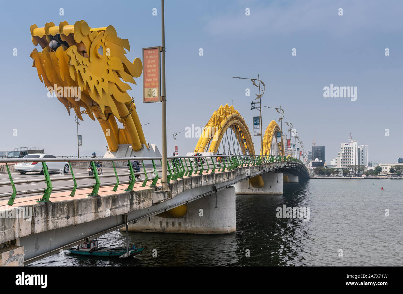 Da Nang, Vietnam - March 10, 2019: Cau Rong or Dragon bridge from east, head, to west, tail under blue sky. Traffic on bridge and Vietnam Television C Stock Photo