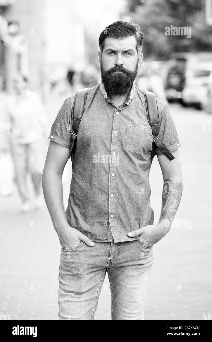 In love with denim. Man bearded hipster fashion model wear denim clothes  urban background stairs. Regular walk in city center. Confident guy wear  jeans denim trousers and shirt. Comfortable outfit Stock Photo 