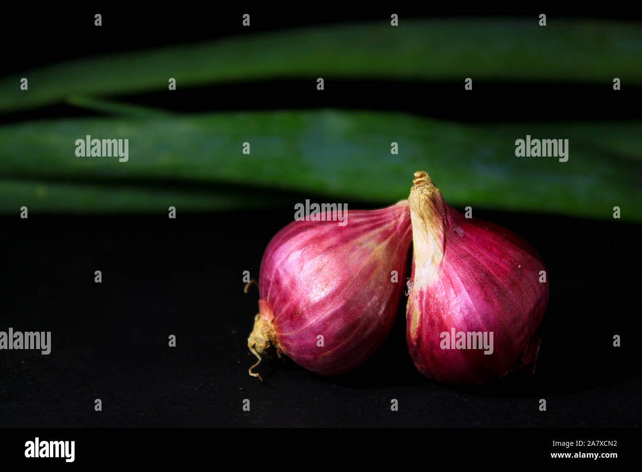 Red onions isolated on black background. Stock Photo
