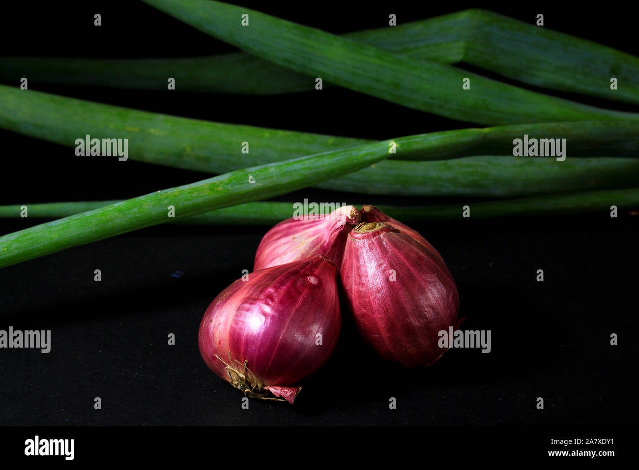 Red onions isolated on black background. Stock Photo