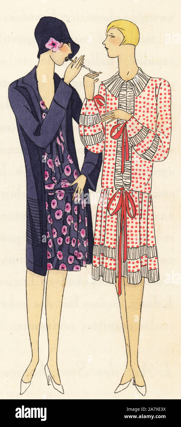 Two women smoking cigarettes. One in a suit of blue muslin printed with fuchsias, and the other in a dress of printed crepe de chine. Handcolored pochoir (stencil) lithograph from the French luxury fashion magazine Art, Gout, Beaute, 1927. Stock Photo