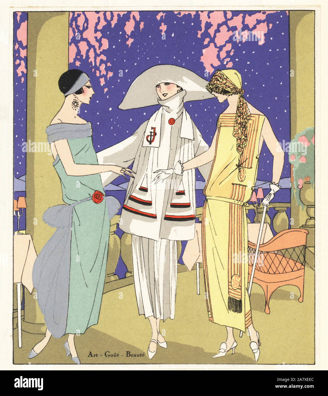 Women at an evening party. One wearing a jade crepe dress, three-piece in white lainage, and gold crepe dress with coral decoration. Handcolored pochoir (stencil) lithograph from the French luxury fashion magazine Art, Gout, Beaute, 1923. Stock Photo