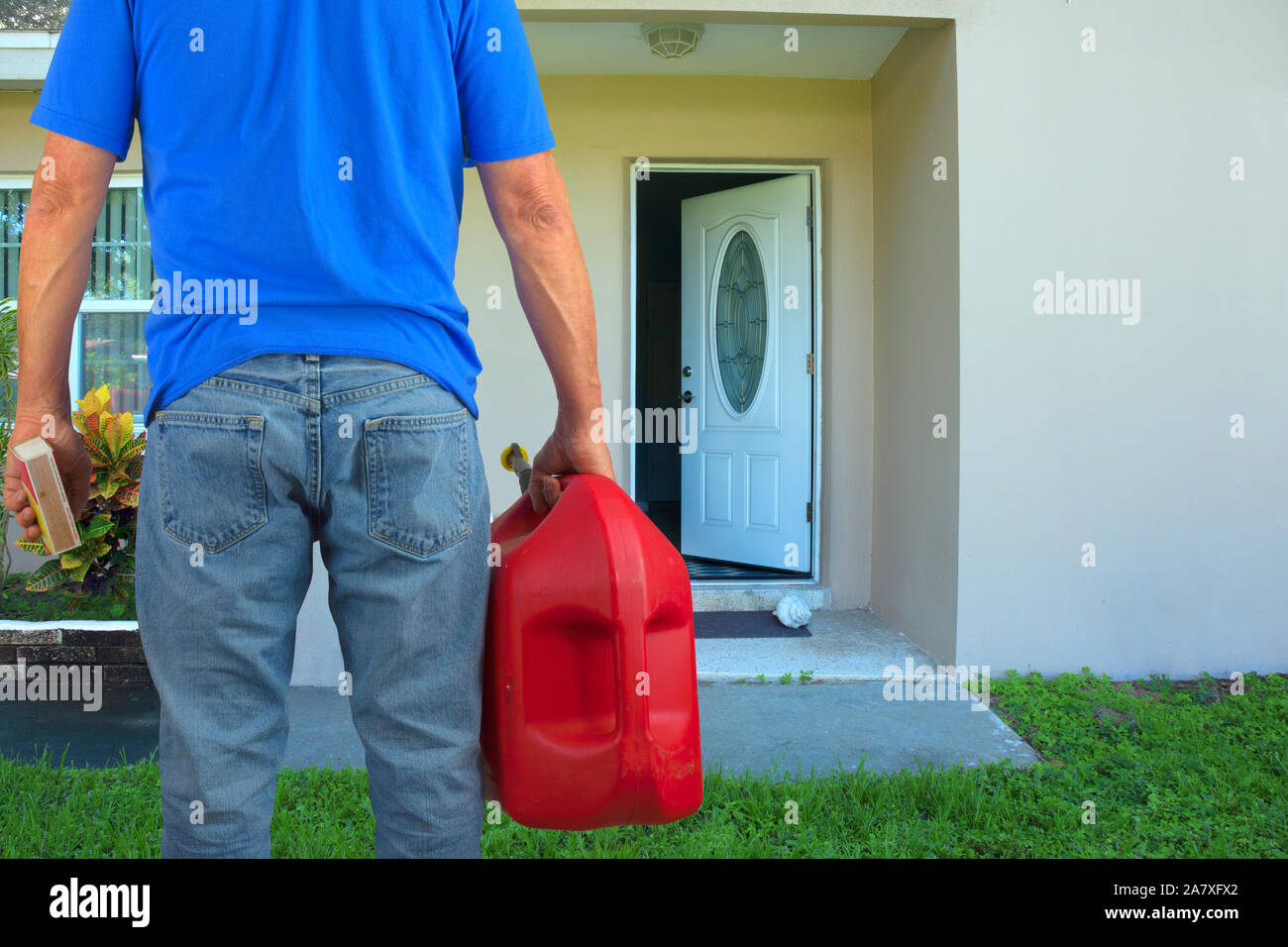 Arsonist man with red plastic gasoline can container and box of striking matches preparing to commit arson crime and maliciously and  intentionally bu Stock Photo