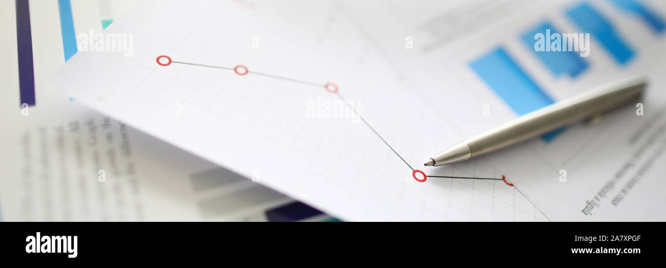 Silver pen lies on documents with Stock Photo