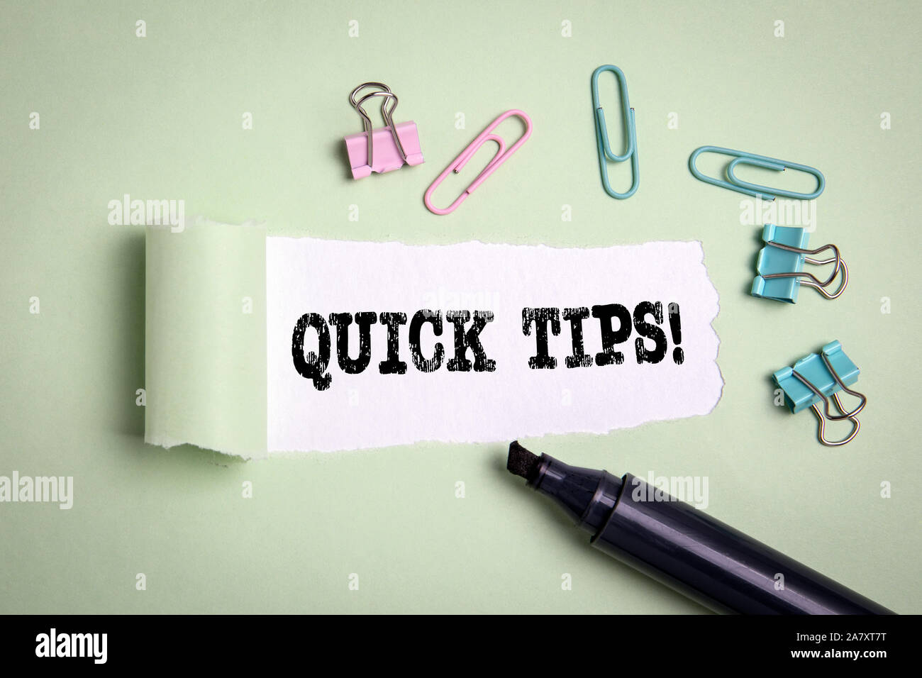Quick Tips. Tutorial, teaching, studying and conference. Text under torn paper Stock Photo