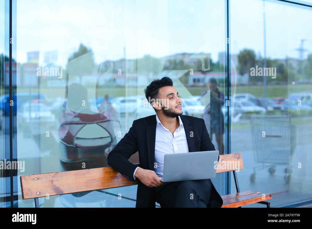 Cool guy arabic man uses laptop business center Stock Photo