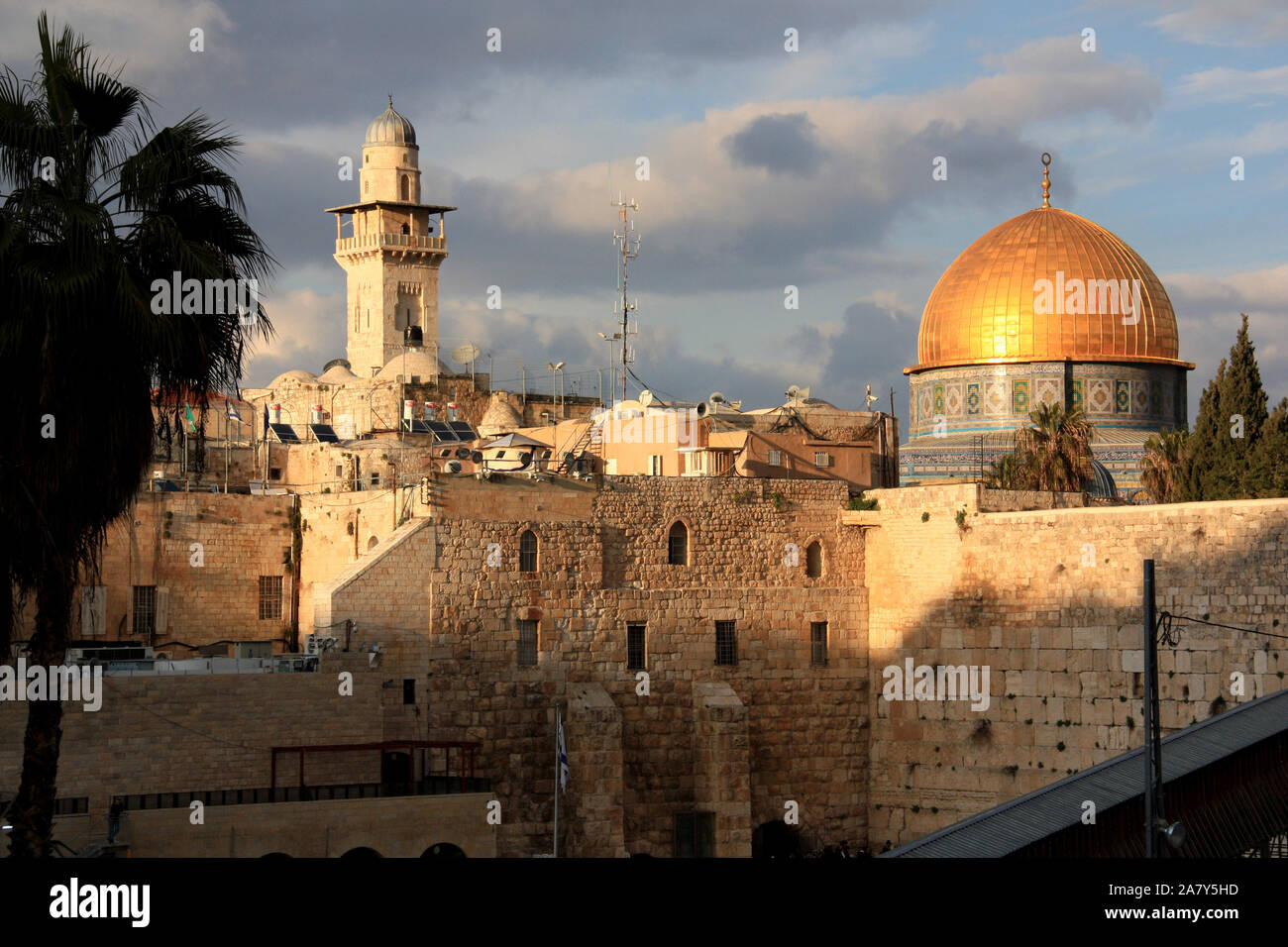 Western Wall and the Dome of the Rock in the holy city of Jerusalem, Israel, during sunset with cloudy sky Stock Photo