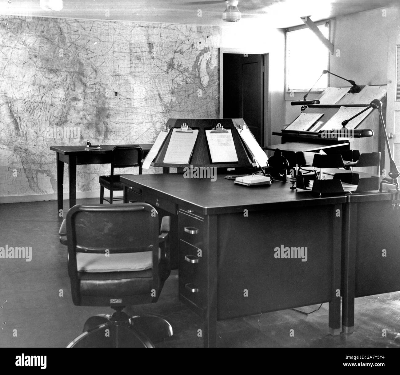 Forecast Desk With World Map on Wall Scottsbluff, NE 1950-1964 Stock Photo