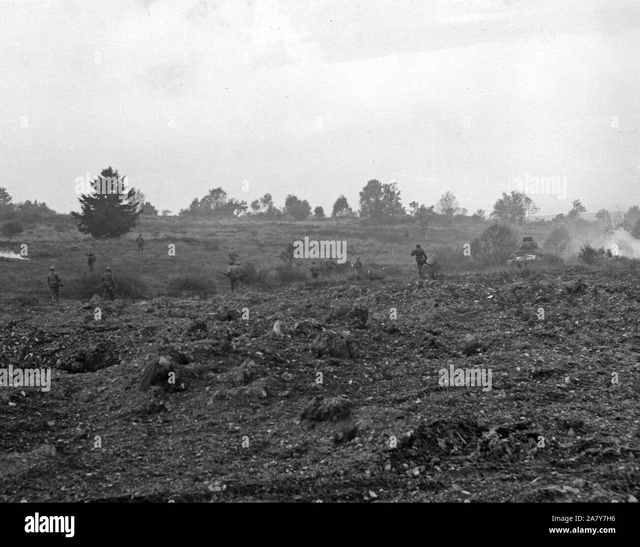 American Infantrymen race across an open field to reach a German pillbox, on the of the German Siegfried line defenses, Eisenboen, Germany, 10 9 44 (28th Infantry Division) Stock Photo