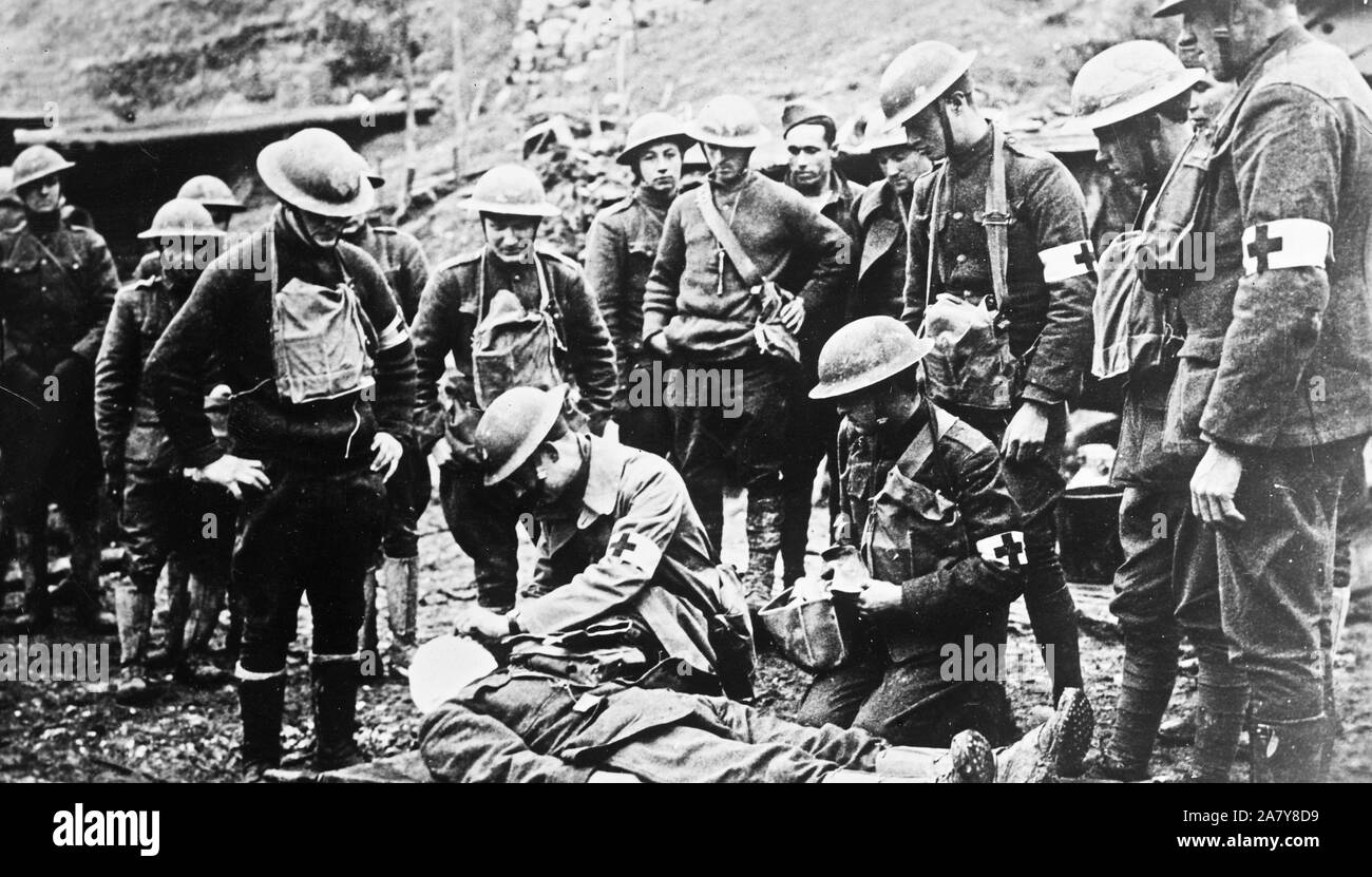 Photograph shows a doctor with an injured American soldier behind the lines in France, during World War I. Stock Photo