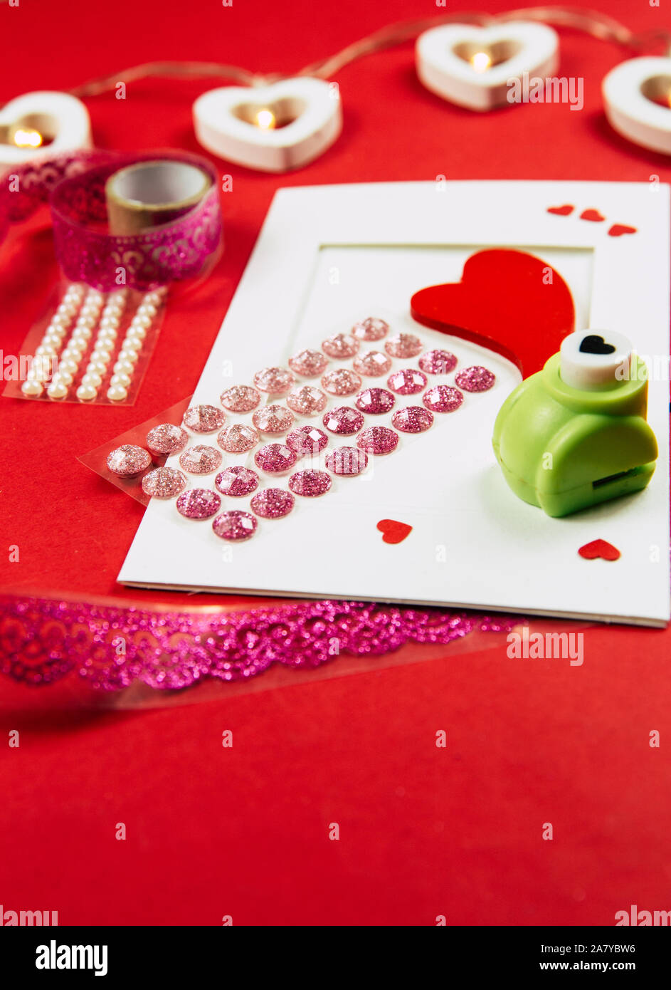 Making Greetings card concept. Various arts and crafts tools on table, red background. Stock Photo