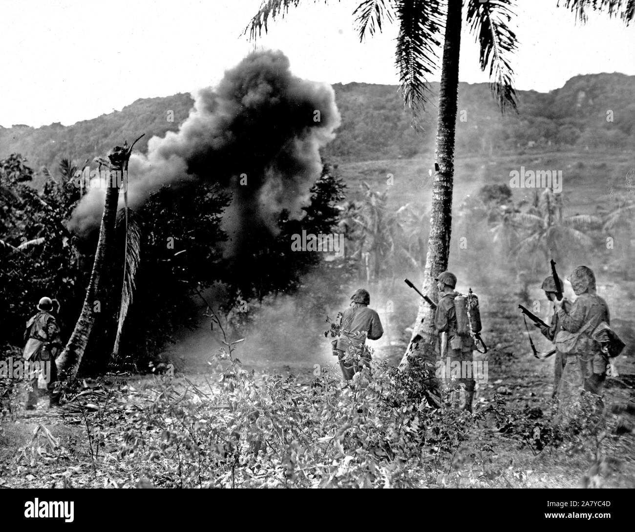 Marines attack a Japenese position with a demolistion charge and shoot soldiers as they flee Stock Photo