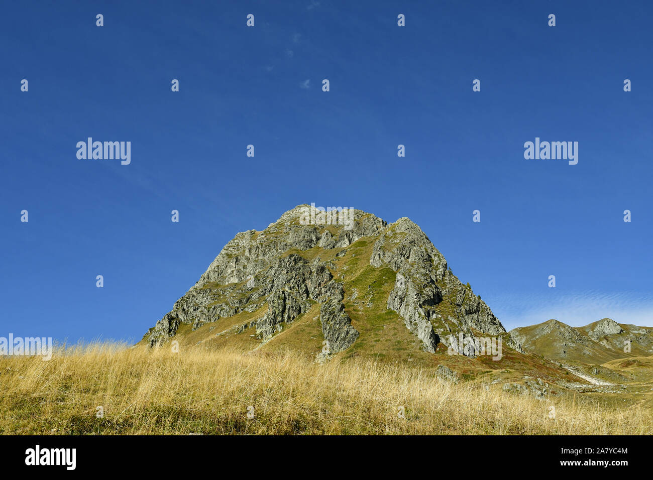 View of Colle Parvetto rocky peak in the Cottian Alps of Piedmont (Northern Italy) against clear blue sky in late summer, Castelmagno, Cuneo, Italy Stock Photo