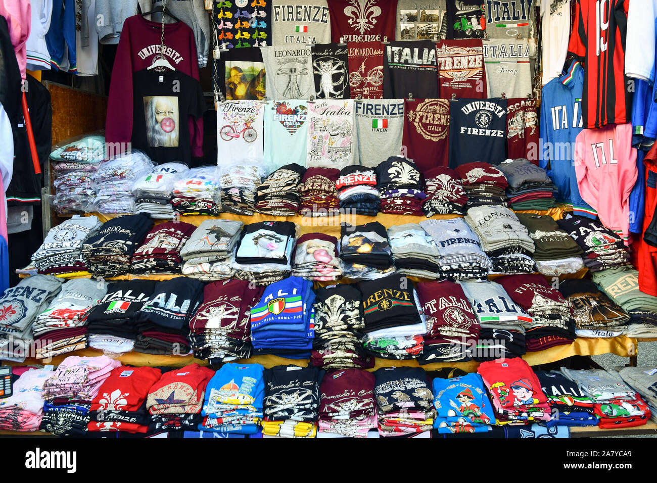 Close-up of a street market stall full of souvenir t-shirts for tourists, Florence, Tuscany, Italy Stock Photo