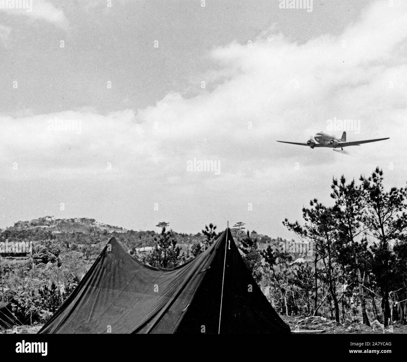 World War II Photo - TAG Douglas Transport Flit Gun - sprays DDT over Okinawa reducing insects by 50 percent. killing lice, mosquitoes with malaria Stock Photo