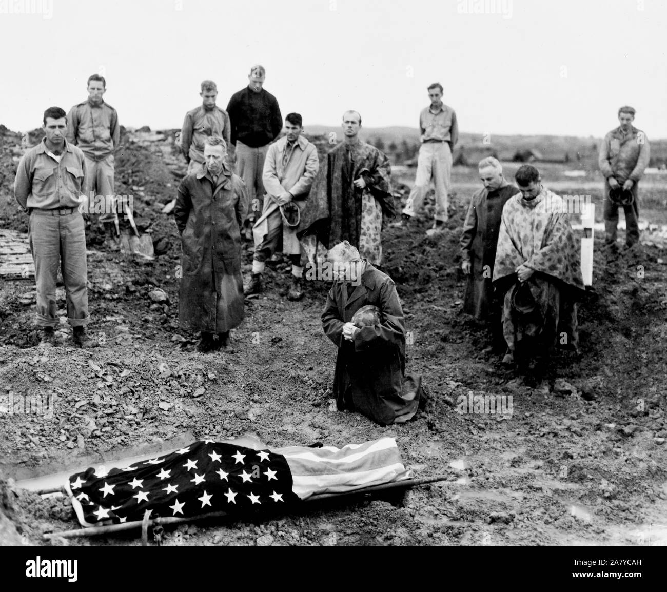 Marine colonel Francis Fenton kneels and prays at the foot of his sons flag draped body , PFC Michael Fenton who was killed in a counter attack on the road to Shuri, Okinawa Stock Photo