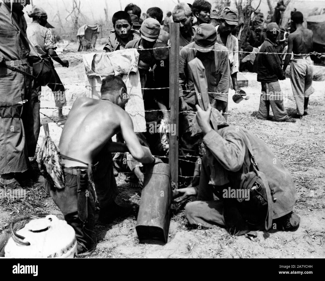 Maines give water to civilian prisoners on Saipan Stock Photo