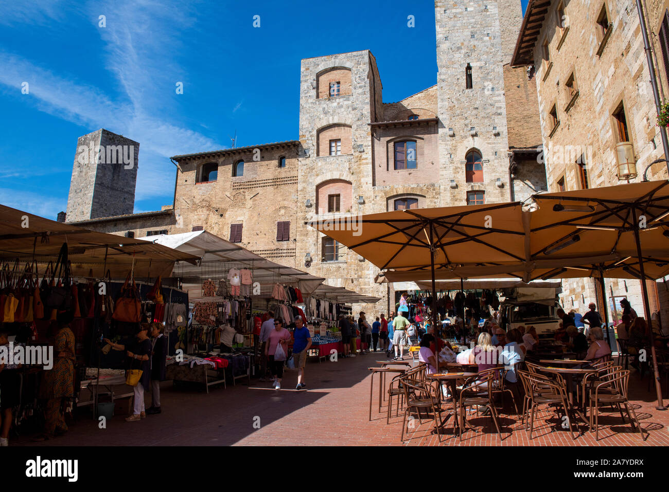 A sunny summer market day in the hill town of San Gimignano, Tuscany Italy Europe EU Stock Photo