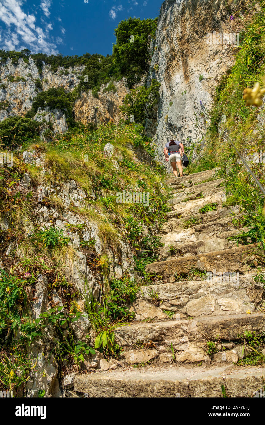 Two unrecognizable persons going up to the steep stairs Stock Photo