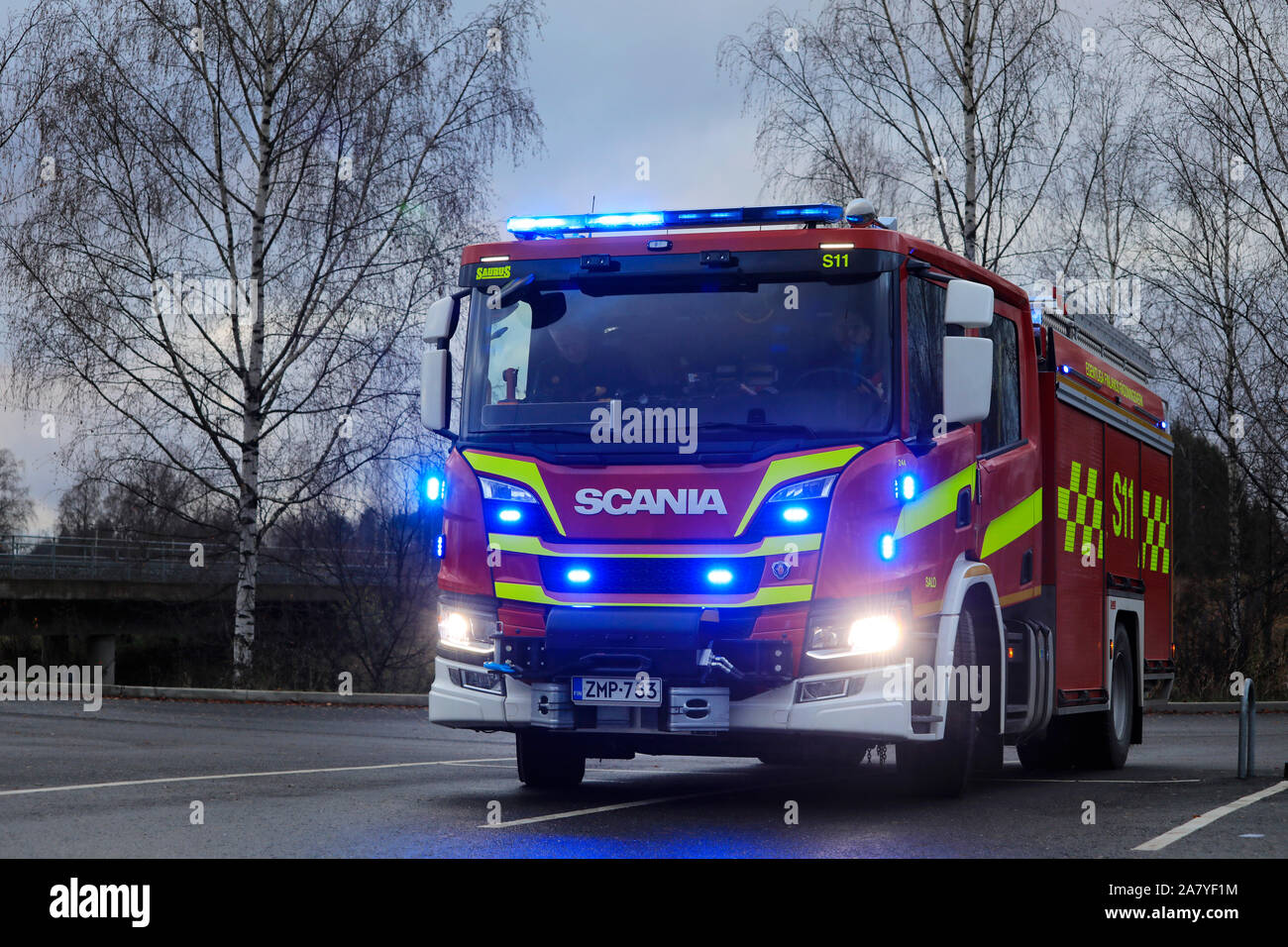 New Scania P CrewCab fire truck with blue lights on. Salo, Finland. November 3, 2019. Stock Photo