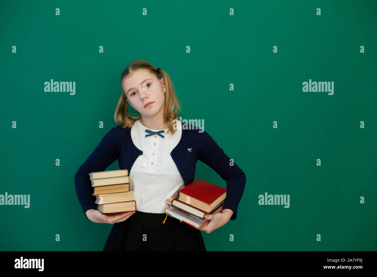 schoolgirl with books in class at the green board Stock Photo - Alamy