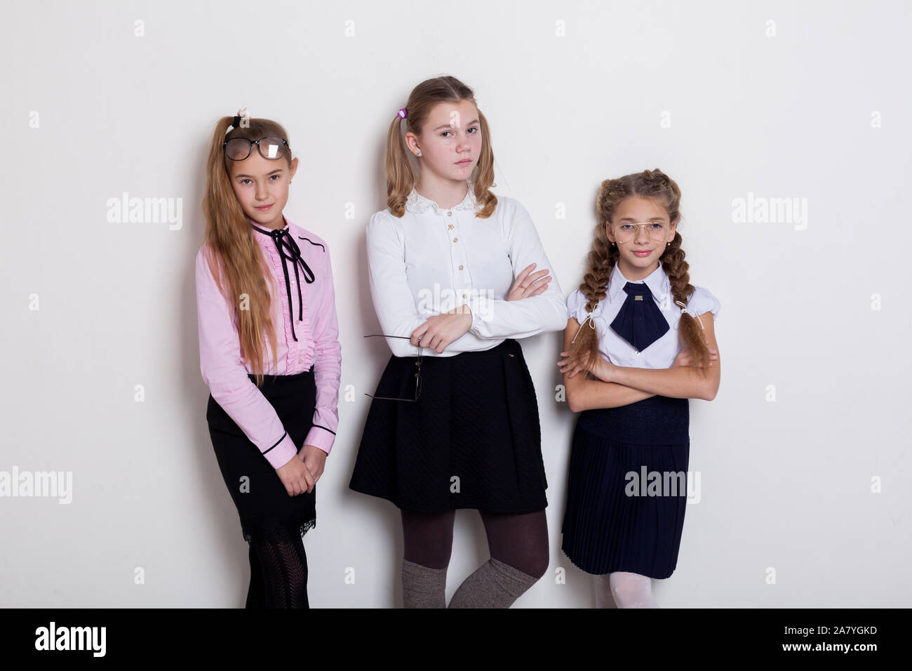 three girls in class at the white wall Stock Photo - Alamy