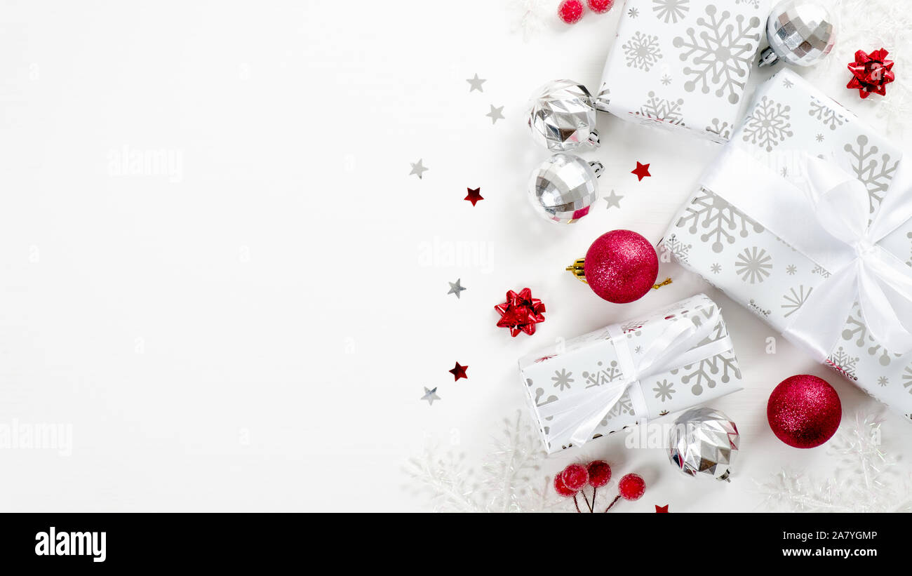 Top view Christmas presents, red and silver decorations on white ...