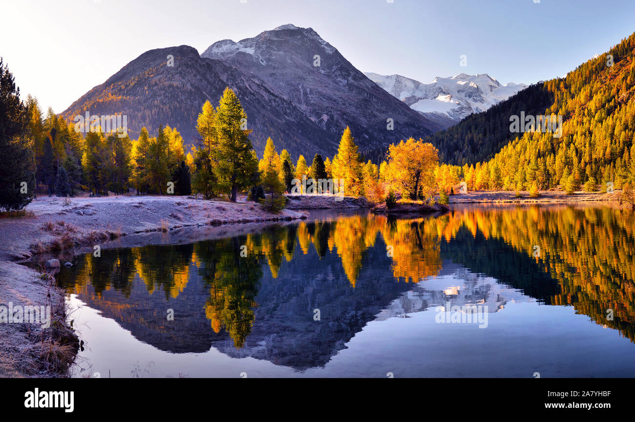 Autumn landscape with reflection in a lake in the alpine mountainsю ...