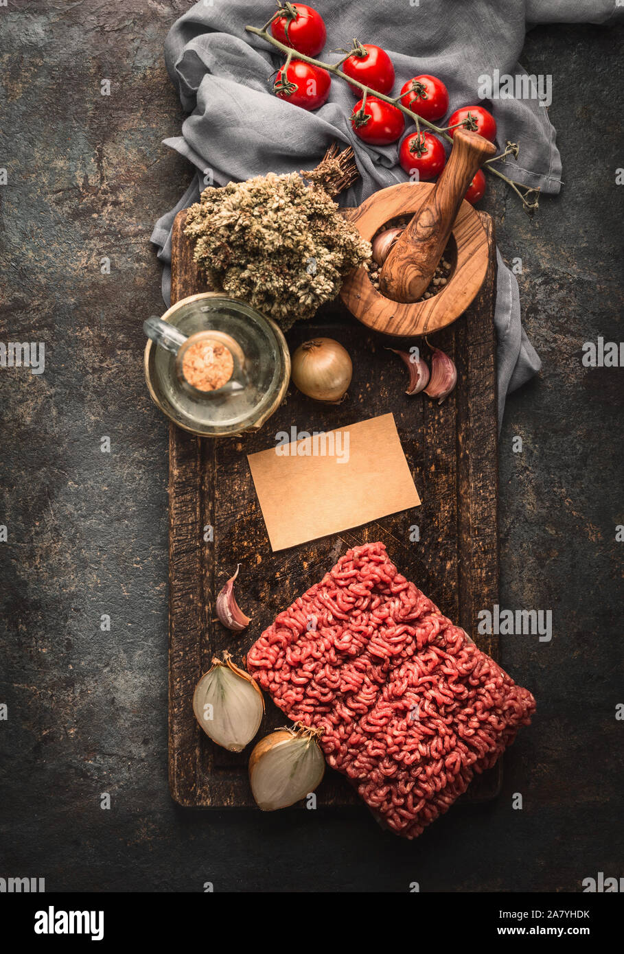 Minced meat und cooking ingredients for Bolognese sauce on dark rustic kitchen table, top view Stock Photo