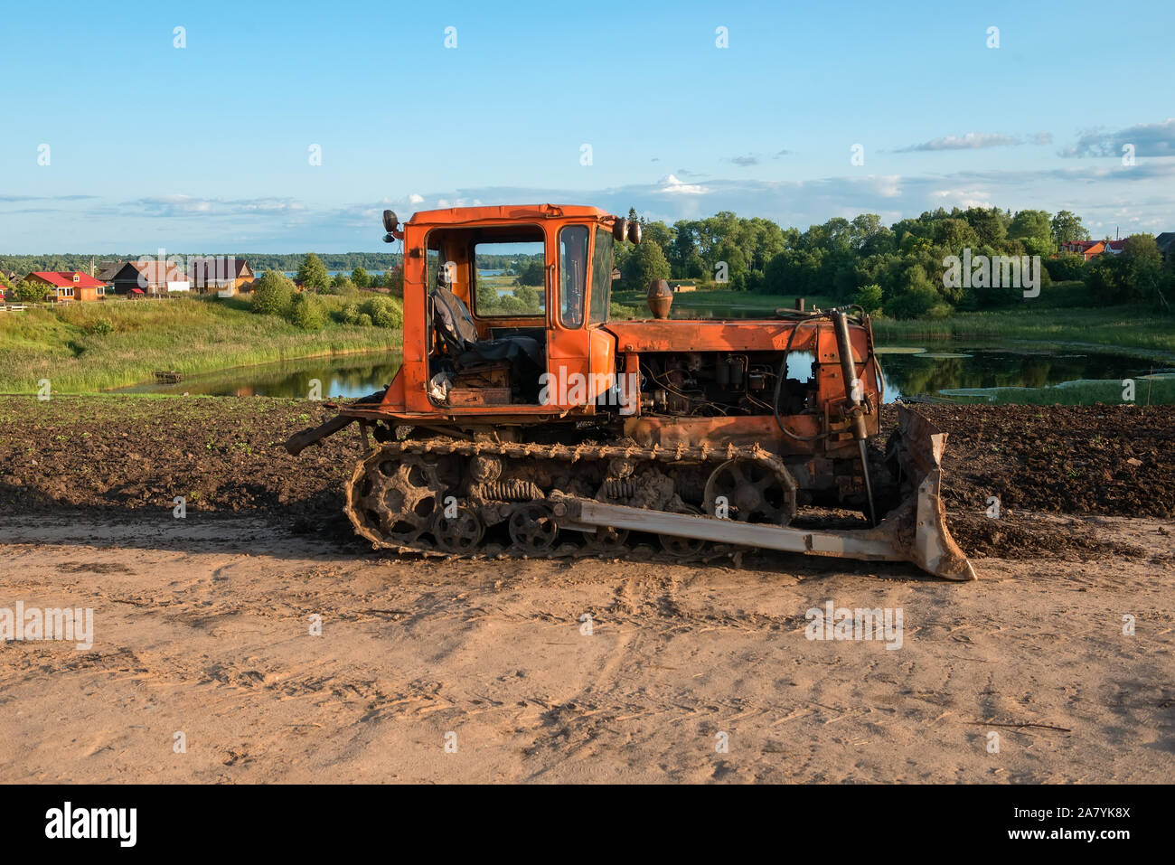 Caterpillar agricultural tractor DT-75 in the countryside Stock Photo