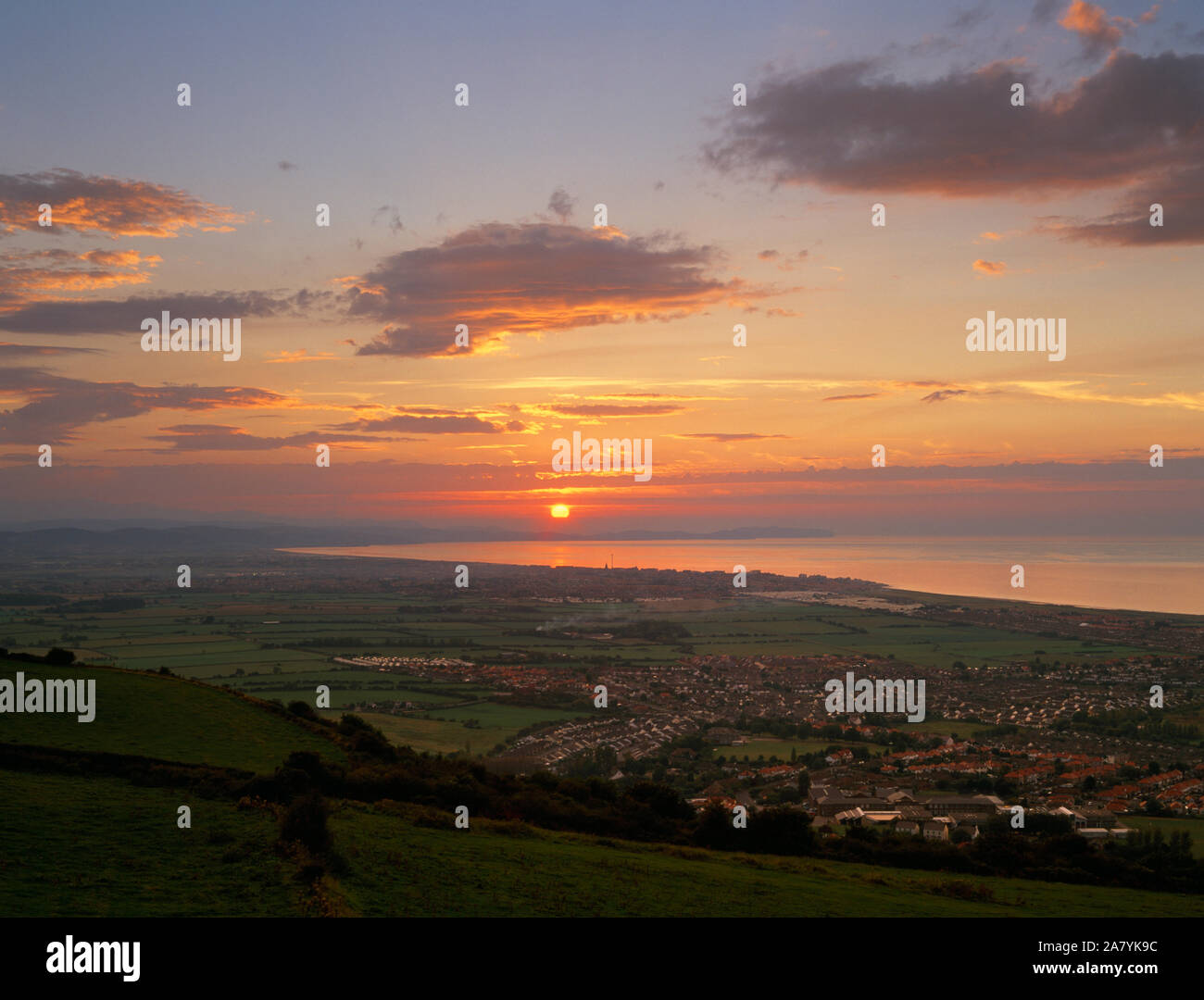 Sunset and North Wales coast seen from Offa's Dyke long distance footpath, above Prestatyn, Denbighshire. Stock Photo