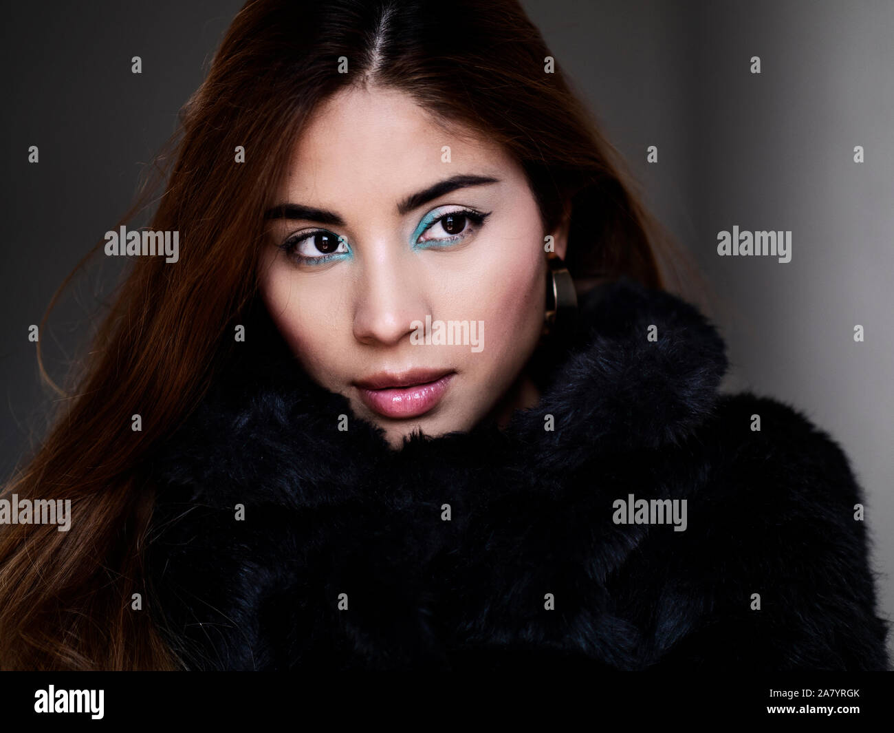 Beautiful young woman wearing black fur coat Stock Photo - Alamy