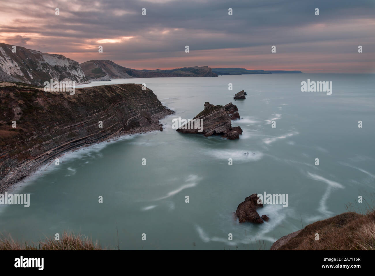 Mupe Bay Dorset England Long exposure at dawn on Dorset's Jurassic coast at Mupe Bay, seen from Bacon Hole. Stock Photo