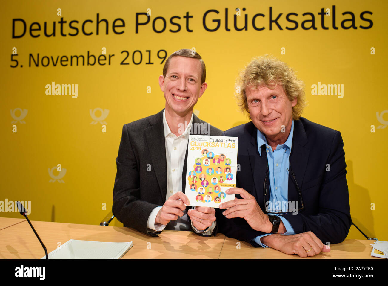 Berlin, Germany. 05th Nov, 2019. Thomas Ogilvie (l-r), Chief Human Resources Officer of Deutsche Post AG, and Bernd Raffelhüschen, economist and professor at the Albert-Ludwigs-University Freiburg, will jointly present the Glücksatlas 2019 at the Haus der Bundespressekonferenz. Credit: Gregor Fischer/dpa/Alamy Live News Stock Photo