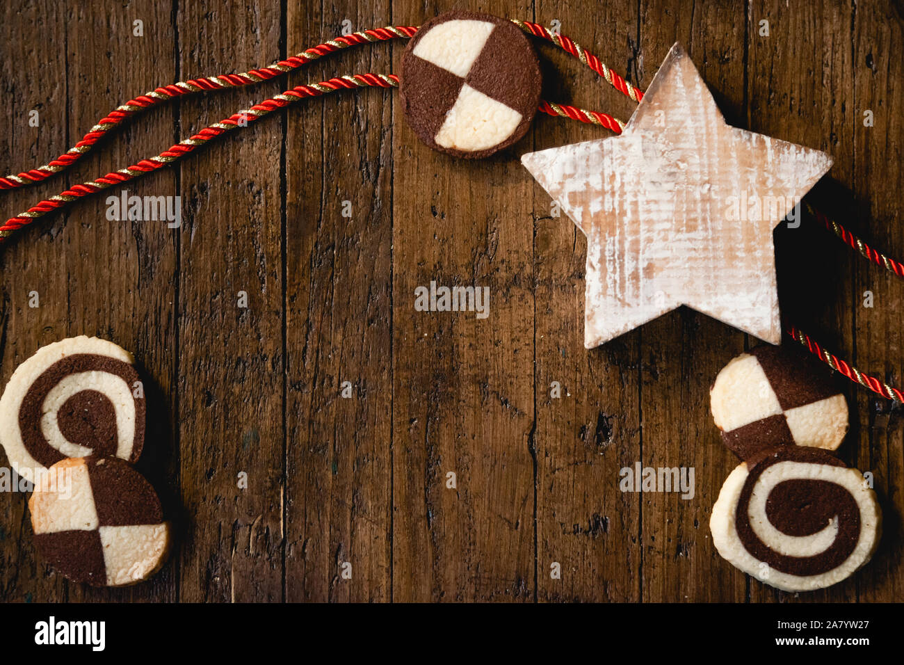 Traditional German Christmas cookies (checkered biscuits) on wooden table with christmas decoration Stock Photo