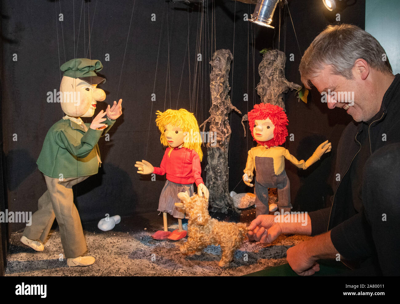 Augsburg, Germany. 05th Nov, 2019. Puppet Master Stefan Schmieder sets up a  scene from the puppet play "Pünktchen und Anton". In the museum of the  Augsburger Puppenkiste marionettes and hand puppets are