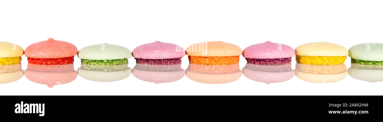 Header, colorful various cookies or macarons in a line, cutout on white background Stock Photo