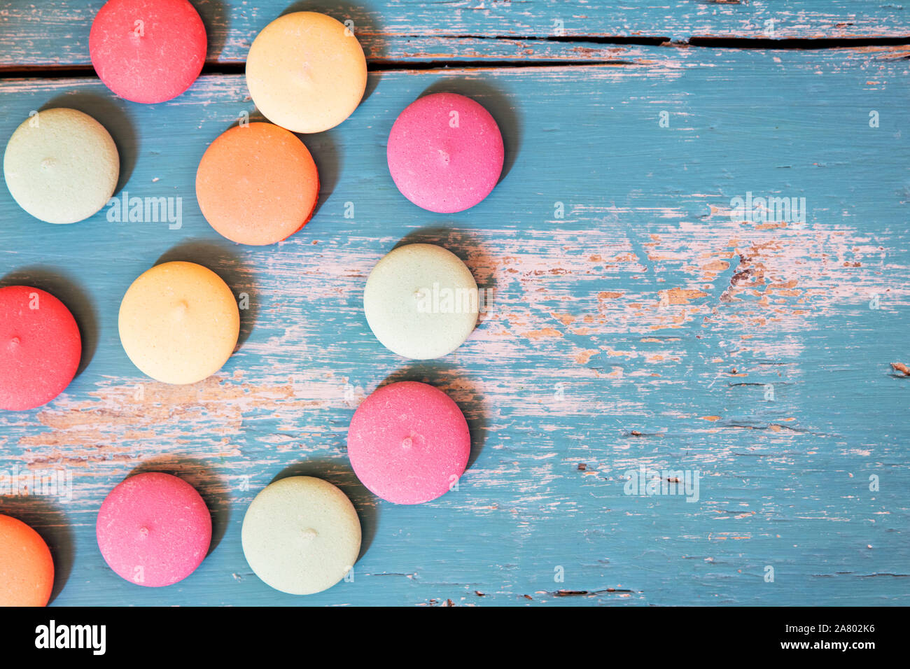 various of colorful biscuits or macarons on blue wooden background, copyspace Stock Photo