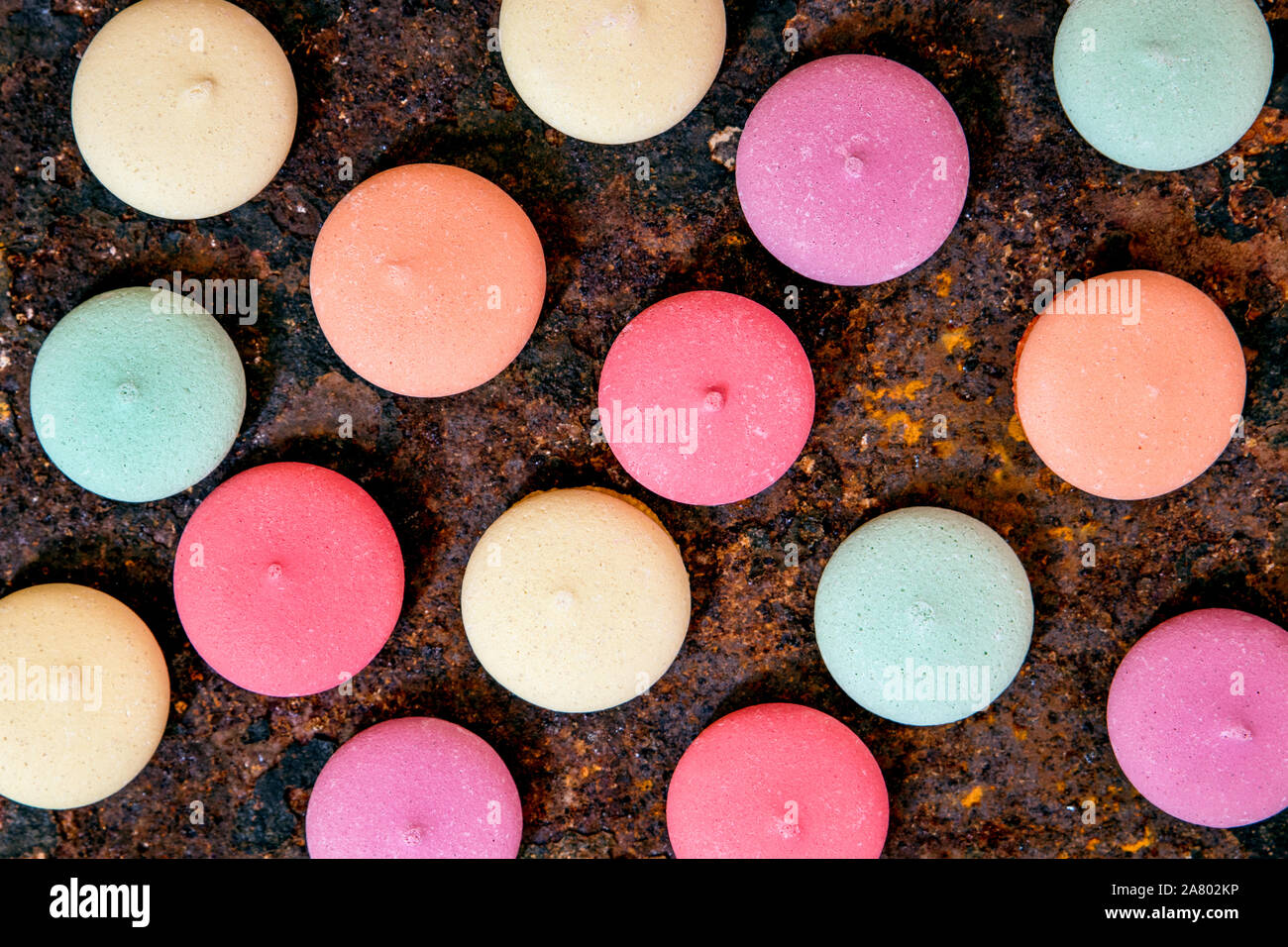 round colorful cookies or biscuits on a rusty background, topview Stock Photo